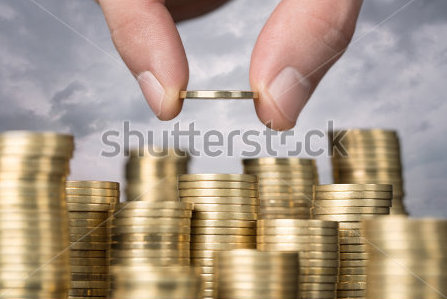 stock-photo-savings-close-up-of-male-hand-stacking-golden-coins-over-sky-background-131090588